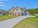 Spacious home featuring a three-car garage and long driveway at 125 Leverett Ct, Fayetteville, GA 30215