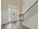 Light-filled foyer with wood floors, elegant trim, and a decorative front door at 125 Leverett Ct, Fayetteville, GA 30215