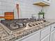 Close-up of a Frigidaire Gallery stovetop with granite countertops and a white subway tile backsplash at 125 Leverett Ct, Fayetteville, GA 30215