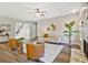 Bright living room with a fireplace, wood floors, neutral walls, stylish furniture, and large windows at 125 Leverett Ct, Fayetteville, GA 30215