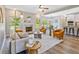 Cozy living room featuring a fireplace, neutral color palette, wood floors, and lots of natural light at 125 Leverett Ct, Fayetteville, GA 30215
