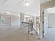 Upstairs loft area featuring carpet, iron railing, pendant lighting, and ample space at 125 Leverett Ct, Fayetteville, GA 30215