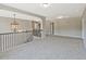 Bright loft featuring carpet, iron railing, pendant lighting, and ample space at 125 Leverett Ct, Fayetteville, GA 30215