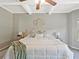 A main bedroom featuring tray ceiling, a decorative wall feature, fan, neutral paint, and carpeted floor at 125 Leverett Ct, Fayetteville, GA 30215