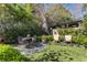 Backyard with stone patio, outdoor seating, manicured hedges, and a tranquil, lush garden setting at 1285 Oakdale Ne Rd, Atlanta, GA 30307