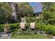 Serene backyard with decorative chairs, manicured lawn, trimmed hedges, and a tranquil garden at 1285 Oakdale Ne Rd, Atlanta, GA 30307