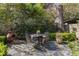 Private backyard featuring stone patio, outdoor seating area, lush landscaping and mature trees at 1285 Oakdale Ne Rd, Atlanta, GA 30307
