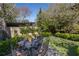 Backyard featuring stone patio, outdoor seating, lush landscaping and mature trees at 1285 Oakdale Ne Rd, Atlanta, GA 30307