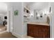 Bright bathroom featuring a wood vanity, a large mirror with sconces, and decor shelving at 1285 Oakdale Ne Rd, Atlanta, GA 30307