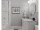 Stylish bathroom features a shower with a glass door, marble countertop, and decorative artwork at 1285 Oakdale Ne Rd, Atlanta, GA 30307