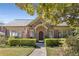 Charming brick home featuring manicured landscaping, arched entryway, and an American flag at 1285 Oakdale Ne Rd, Atlanta, GA 30307