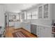 Updated kitchen with stainless steel appliances, white cabinets, tiled backsplash, and hardwood floors at 1285 Oakdale Ne Rd, Atlanta, GA 30307