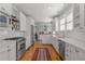Modern kitchen featuring stainless steel appliances, white cabinets, tiled backsplash, and hardwood floors at 1285 Oakdale Ne Rd, Atlanta, GA 30307