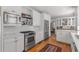 Bright kitchen featuring stainless steel appliances, white cabinets, tiled backsplash, and hardwood floors at 1285 Oakdale Ne Rd, Atlanta, GA 30307