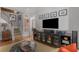 Open-concept living room with hardwood floors, a media center, a staircase, and decorative artwork at 1285 Oakdale Ne Rd, Atlanta, GA 30307