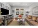 Cozy living room featuring a brown sofa, chair, coffee table, and built-in media center with a large TV at 1285 Oakdale Ne Rd, Atlanta, GA 30307