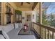 Inviting covered porch featuring a comfortable cushioned sectional, wicker coffee table, and decorative accents at 1285 Oakdale Ne Rd, Atlanta, GA 30307