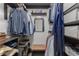 Well-organized walk-in closet featuring shelving, hanging space, a mirror, and stool at 1285 Oakdale Ne Rd, Atlanta, GA 30307