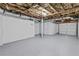 Spacious unfinished basement with garage door and exposed ceiling offers ample room at 2241 Glendale Dr, Decatur, GA 30032