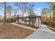 Charming single-story home with concrete walkway, complemented by lush landscaping and mature trees at 2241 Glendale Dr, Decatur, GA 30032