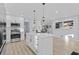 Spacious kitchen features white cabinets, stainless steel appliances, quartz counters, and an island at 2241 Glendale Dr, Decatur, GA 30032