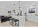 Bright open concept kitchen with island, white cabinets, and stainless steel appliances open to the living room at 2241 Glendale Dr, Decatur, GA 30032