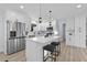 Bright kitchen features white cabinets, stainless steel appliances, quartz counters, and an island with seating at 2241 Glendale Dr, Decatur, GA 30032