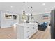 Bright, open concept kitchen with white cabinets, stainless appliances, and island adjacent to the living area at 2241 Glendale Dr, Decatur, GA 30032