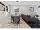 Light-filled open living space with neutral palette, wood-paneled walls, and a combined dining area at 2241 Glendale Dr, Decatur, GA 30032