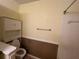 Cozy bathroom featuring a toilet, bathtub, tiled walls and a storage cabinet at 25 Fair Haven Way, Smyrna, GA 30080
