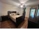 Cozy bedroom with ceiling fan, hardwood flooring, and natural light from the windows at 25 Fair Haven Way, Smyrna, GA 30080