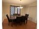 Formal dining area with decorative lighting and view of the backyard through sliding glass doors at 25 Fair Haven Way, Smyrna, GA 30080