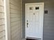 The front door of the home is white with a gold door handle at 25 Fair Haven Way, Smyrna, GA 30080