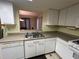 Practical kitchen with white cabinets, a double sink and easy access to dining and living areas at 25 Fair Haven Way, Smyrna, GA 30080