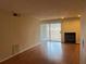 Bright living area with hardwood flooring, fireplace, and sliding glass door at 25 Fair Haven Way, Smyrna, GA 30080