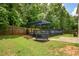 Backyard with a fenced in pool, wooden deck covered by a pergola, and well-maintained lawn at 3131 Leyland Ct, Decatur, GA 30034