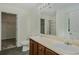 Bathroom featuring double vanity, framed mirror, and a glass-enclosed shower at 3131 Leyland Ct, Decatur, GA 30034