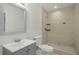 Bathroom with tile shower, vanity, and gray cabinet at 3131 Leyland Ct, Decatur, GA 30034