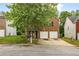 Charming brick home with a two-car garage and mature tree in the front yard at 3131 Leyland Ct, Decatur, GA 30034
