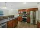 Spacious kitchen featuring stainless steel appliances, dark countertops and tiled flooring at 3131 Leyland Ct, Decatur, GA 30034
