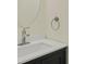 Neutral powder room featuring modern chrome faucet and round mirror at 3131 Leyland Ct, Decatur, GA 30034