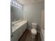 Bathroom featuring a vanity, framed mirror, and a toilet at 930 Parkway Rd, Union City, GA 30291