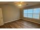 Bright bedroom features a ceiling fan, natural light, and wood-look flooring at 930 Parkway Rd, Union City, GA 30291