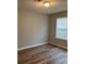 A cozy bedroom with natural light, laminate flooring, and a ceiling light at 930 Parkway Rd, Union City, GA 30291