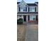 Exterior shot of a two story townhome featuring brick and landscaping at 930 Parkway Rd, Union City, GA 30291