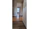 Hallway view showing newly installed wood grain floors, leading to a bedroom with abundant natural light at 930 Parkway Rd, Union City, GA 30291