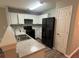 A kitchen featuring stainless steel appliances, white cabinets, and granite countertops at 930 Parkway Rd, Union City, GA 30291