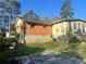 Back exterior of a home with a blend of brick and siding, complemented by a modest backyard at 2019 Thomasville Se Dr, Atlanta, GA 30315