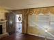 Entryway of home with decorative door, stone fireplace, and window with curtains at 2019 Thomasville Se Dr, Atlanta, GA 30315