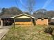 Charming single-story brick home with a covered porch, mature trees, and well-maintained lawn at 2019 Thomasville Se Dr, Atlanta, GA 30315